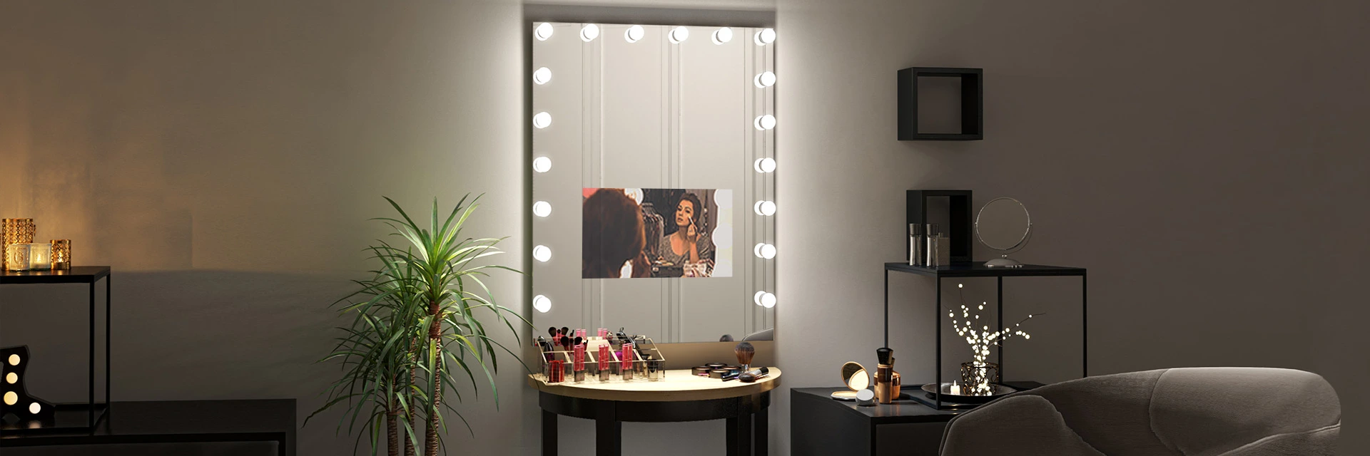 Dracaena plant beside an illuminated mirror TV showing a make up tutorial.