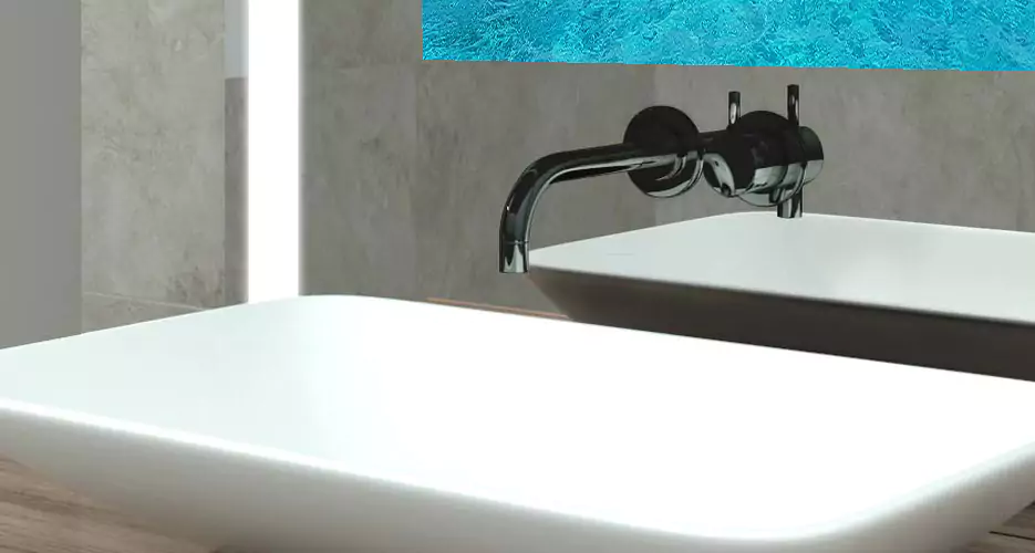 White limestone basin with black single faucet.